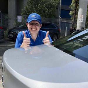 Australia's Detailing Group Bribie Island employee posing with finished car